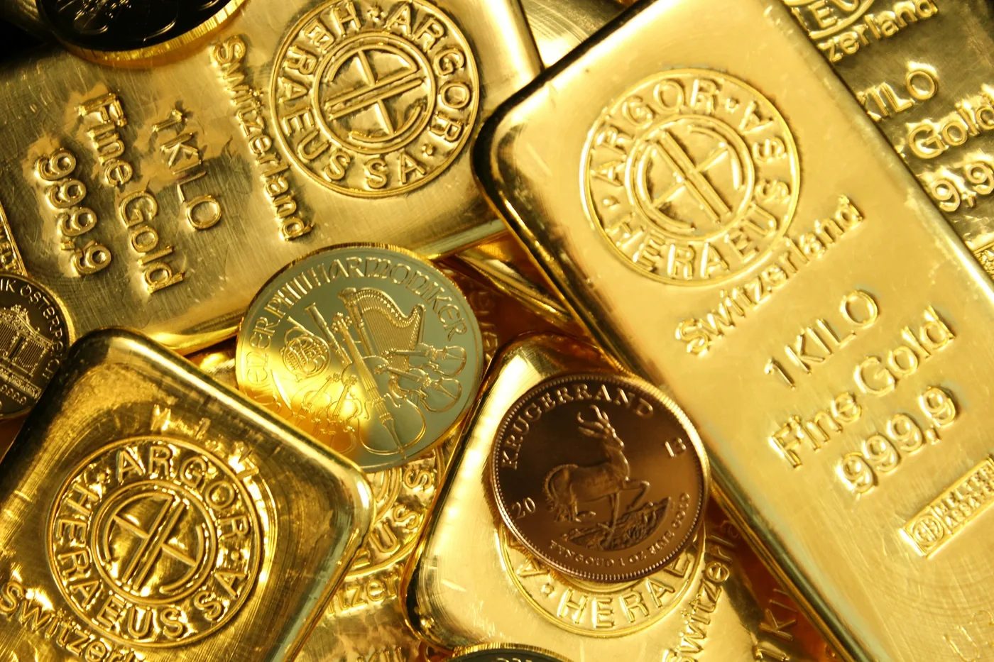 A Krugerrand coin among kilo gold bars